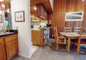 Homey Condo, Right Across from The Village! Forested Setting & Balcony