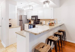 Lake-view condo in gated 14-acre community with private marina, pools, & hot tub