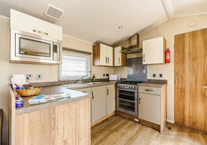 Modern and contemporary 12ft-wide caravan with one double and one twin.