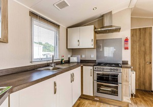 Modern and contemporary 12ft-wide caravan with one double and two twin.