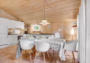 On a hilly natural plot surrounded by trees, lies this beautiful wooden vacation home.