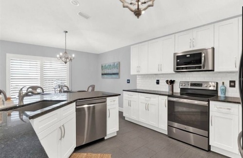 New Smyrna Beach House | 3rd house from beach with heated pool & tiki bar. 2 master suites + 2 bedrooms.
