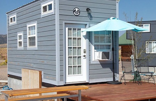 Meeker House | Adorable Tiny Home with two lofts. Both are accessible by ladder. One has a Queen mattress and the other has a Twin mattress. Home also contains a folding Full futon on main level. Sleeps: 4