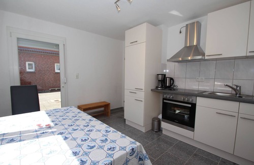 Carolinensiel Apartment | Apartment in Carolinensiel with a high chair and bed