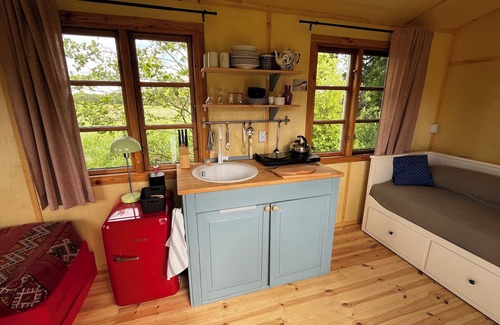 Oetzen Cabin | Beautiful circus wagon on the sheep pasture