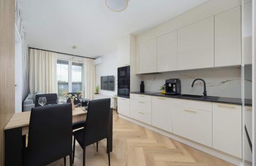 Wlochy Apartment | Beige Apartment in Warsaw with Parking and Air Conditioned Living Room by Noclegi Renters