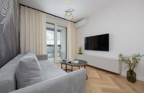 Wlochy Apartment | Beige Apartment in Warsaw with Parking and Air Conditioned Living Room by Noclegi Renters