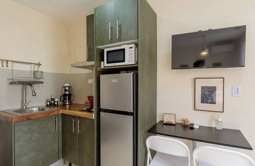 Zona Colonial Apartment | Bohechio studio with private balcony, pool views, ensuite bath, and kitchen.