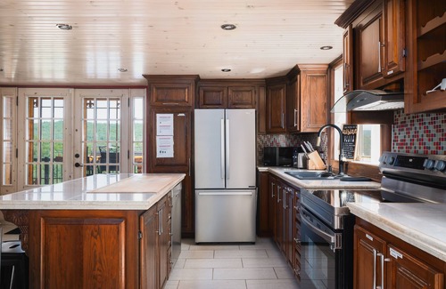 Mandeville Cabin | Charming log cabin nestled in the woods, with a spa and in-ground pool.