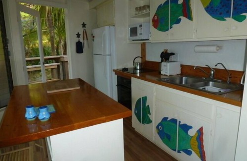 Green Turtle Cay Cottage | Coco Nut Tree House is nestled in Tropical Foliage on Crystal Clear Sea of Abaco