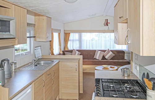 Gwespyr House | Comfortable 12ft-wide caravan with one double and one twin.