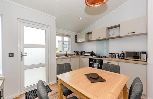 Penrith Ski Chalet | Contemporary semi-detached lodge with master double with Smart TV and en suite with walk in shower.