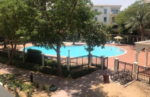 Dubai Investment Park Apartment | Cozy Bedroom Retreat in Green Community Pool View