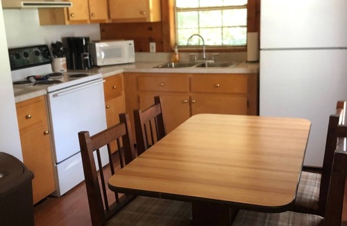 Oneida Cabin | cozy cabin in the woods in a relaxing area with wrap around porch rocking chairs
