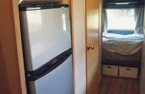 Larkspur House | Cozy camper by the creek, surrounded by serenity and nature.