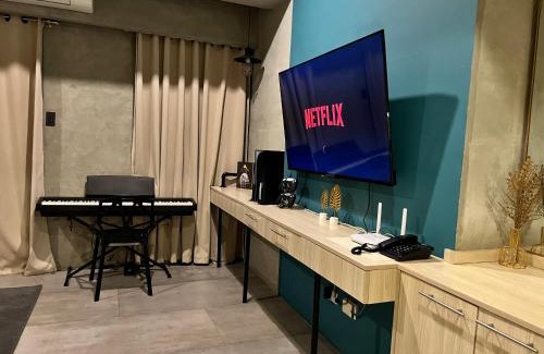 Kaunlaran Apartment | Cozy Spacious Hotel Type Condo with PS5 Smart TV and WiFi