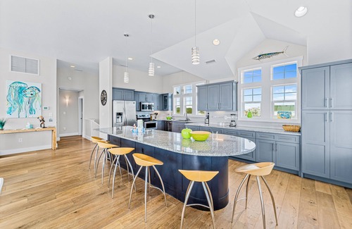 Salvo House | Dazzling waterfront home with balconies, private pool, hot tub, & game room