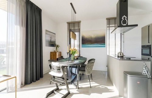 Zeewolde House | Detached 4-person villa with garden by the water, private jetty, fully equipped kitchen, and stylish living room with lots of natural light.
