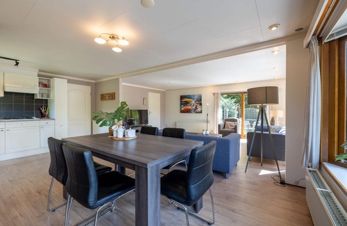 Municipality of Harderwijk House | Discover the beautiful Veluwe Lodges: a spacious and comfortable retreat to relax. Enjoy the cozy living room, open kitchen, and private garden.