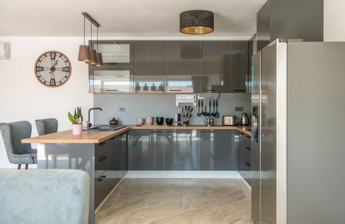 Kozljani House | Enjoy a relaxing time in this modern vacation home with pool.