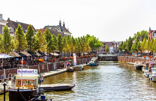 Raamsdonksveer Apartment | Enjoy a stylish room designed for both relaxation and productivity. Sleep soundly on a luxurious box-spring bed (twin or double setup), work or dine comfortably at your table, and stay cool with air conditioning. Your private bathroom, TV, and fridge