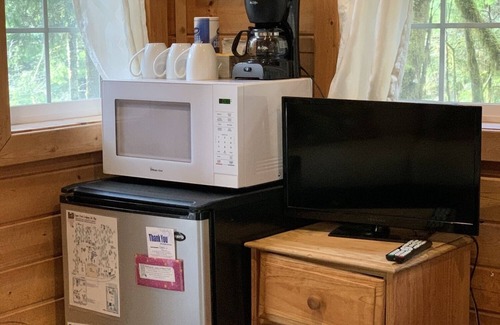 Ashford Cabin | Experience a custom built tiny home cabin near Mt Rainier National Park. It sleeps up to three! Firepit, access to shared hot tub, walking distance to Copper Creek Restaurant