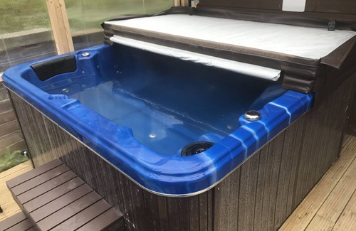 Ynysddu Cabin | Finnish Holiday Lodges, set in wooded hillside, with mountain and stream views