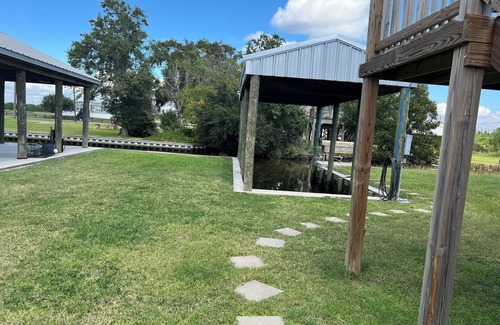 Hackberry House | Fishing camp with boat stall cleaning table three bedroom two bath
