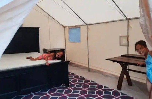 Auburn RV Rental | Glow in the dark Pickleball and Glamping in 16x14 canvas tent with Queen setup