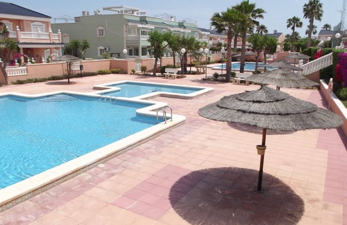 Los Arenales del Sol Apartment | Ground floor corner apartment with WIFI, spacious sunbathing area and pool views