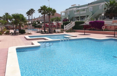Los Arenales del Sol Apartment | Ground floor corner apartment with WIFI, spacious sunbathing area and pool views