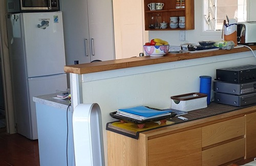 Mahurangi West Cottage | Iconic New Zealand beach cottage with elevated harbour and bush views.