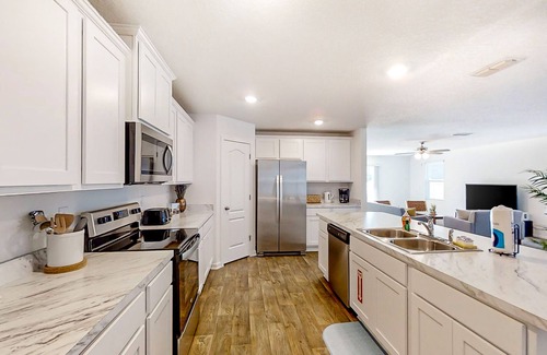 Northside House | Lake-view home with central AC, streaming, washer/dryer, patio, & full kitchen