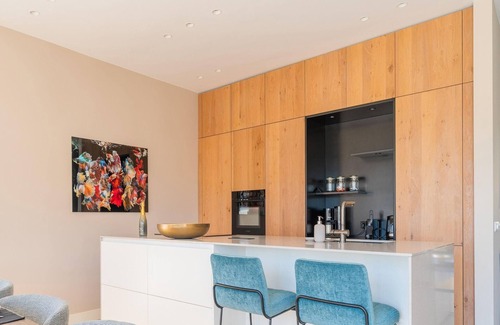 Zeewolde House | Luxury 6-person villa with private infrared sauna, outdoor shower, balcony with water views and sunny fenced garden with private dock. Located at Villa Resort Harderwold.