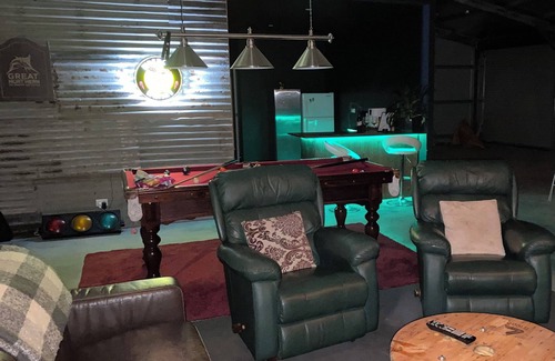 Mount Doran House | Man Cave with a touch of Lux. and an open fire.