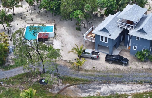 Roatan House | Modern 2 Bedroom Beachfront Home - Steps from the Sea w/Patio, Shared Pool&Dock