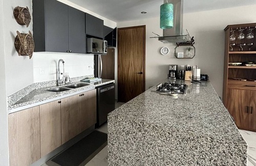 Bucerias Apartment | Modern penthouse with private terrace -18 unit bldg- 1/2 block from the beach.
