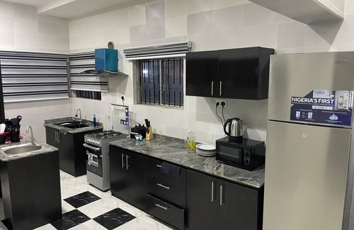 Abeokuta House | Newly renovated almost heaven 2 bdrm; large living room with view of courtyard.