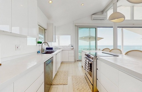 Makaha House | Oceanfront home with wrap around lanai, private sauna, beach access & WIFI