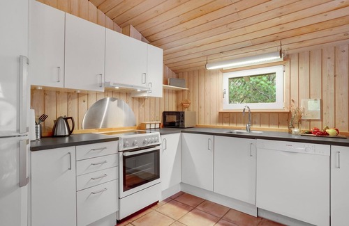 Vorupør House | On a hilly natural plot surrounded by trees, lies this beautiful wooden vacation home.