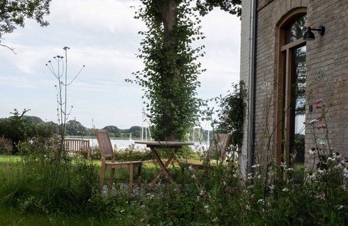 Ulsnis Apartment | Our 1-room vacation apartment "Kleines Fährhaus" is ideal for couples or friends who want to enjoy a quiet break, with a great view of the Schlei from the entire apartment