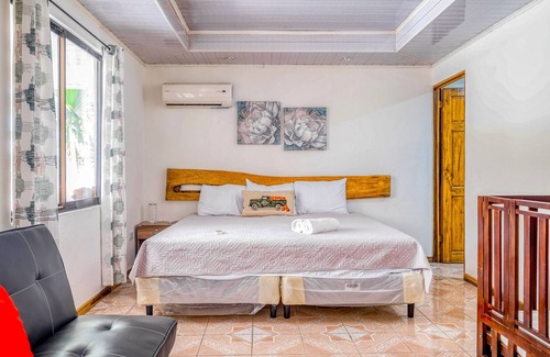 Garabito House | Palm-lined paradise with a pool, wood stove, & mountain views - dog-friendly