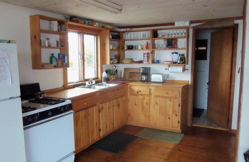 Matinicus Cottage | Private setting at ocean's edge and next to sandy beach