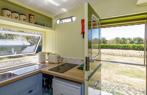 Birdham House | Restored Showman's Carriage with King Bed