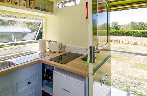 Birdham House | Restored Showman's Carriage with King Bed