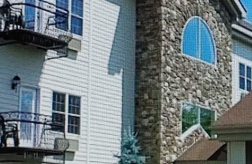 Lake Harmony Resort | Romantic getaway- hot tub and fireplace with a picturesque view of Lake Harmony!