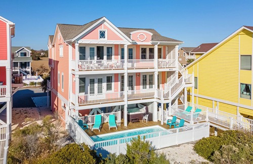 Holden Beach House | "Salty Pink Flamingo" is a stunning 6-bedroom, 4-bathroom oceanfront retreat with a private pool, hot tub, and elevator.