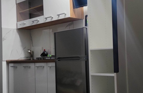 Lochgau Condo | Small room with kitchenette and private bathroom.