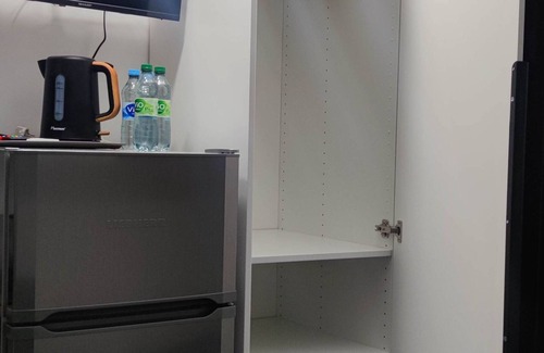 Lochgau Condo | Small room with kitchenette and private bathroom.