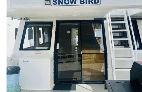 Lake Cowichan Boat Rental | “Snowbird” Houseboat with roof top Hot tub and Slide.